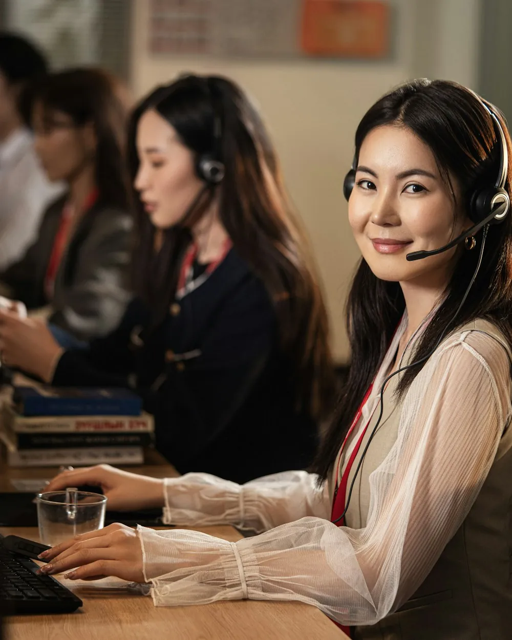 Logistics support agent wearing a headset at her computer &mdash; Surya Rapaka System